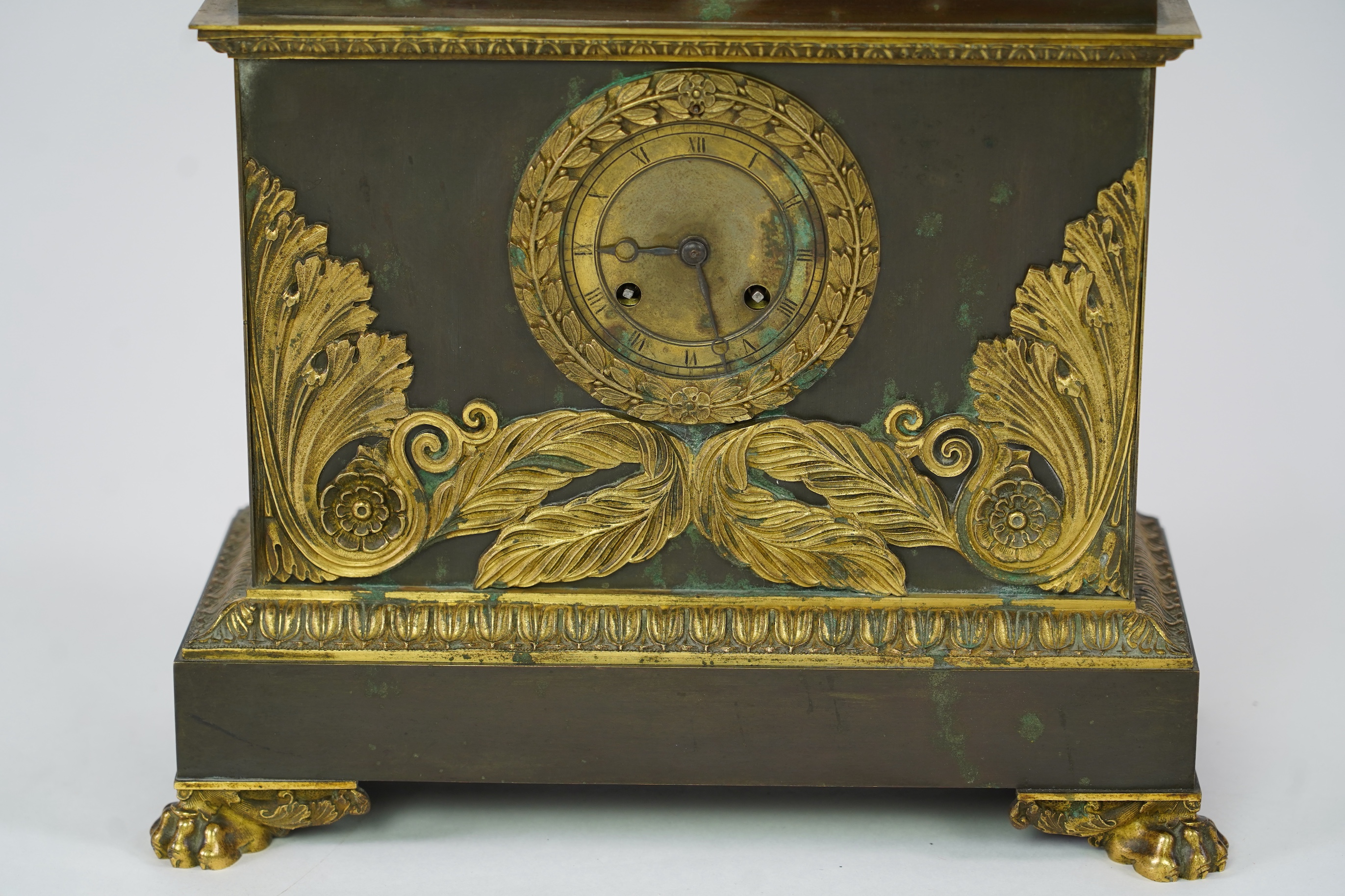 A late nineteenth century brass and bronze cased clock, mounted with a part gilt bronze of a mounted Turkish soldier and woman